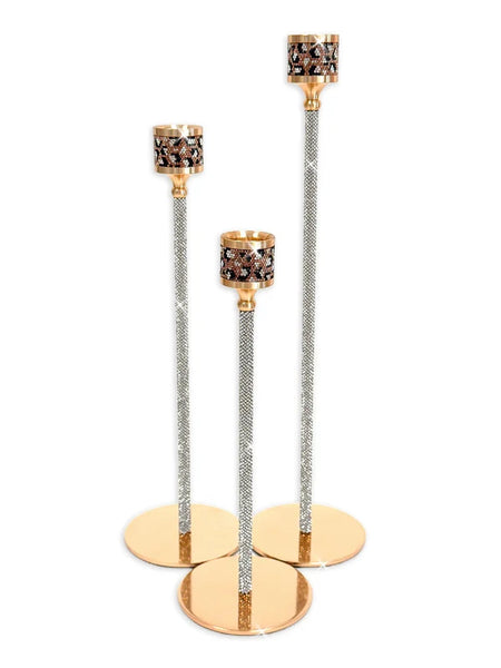 Three gold and silver rhinestone candlesticks of different heights on a white background.
