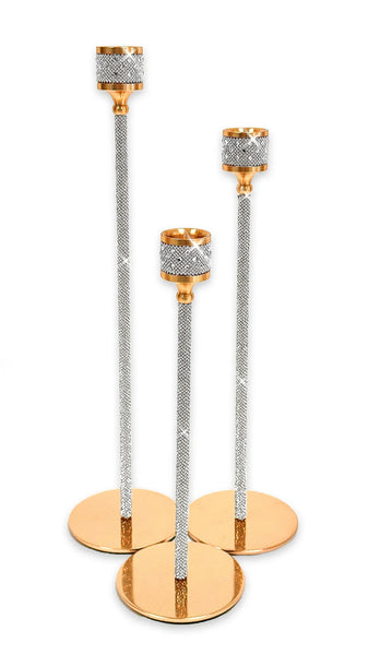 Three rose gold candlestick holders with textured silver crystal-embellished stems and round gold-toned bases, arranged on a white background.