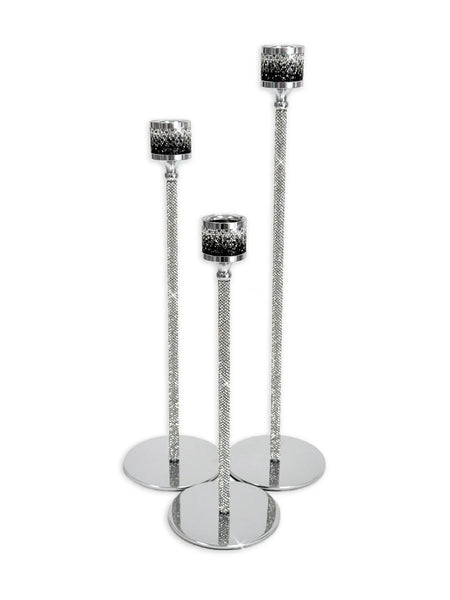 Three silver glitter candlestick holders with round bases and textured black and silver candle cups, arranged on a white background.